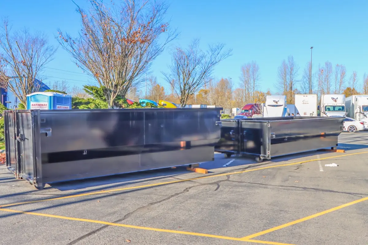 Professional dumpster rental service with roll-off container on residential driveway in Eliot